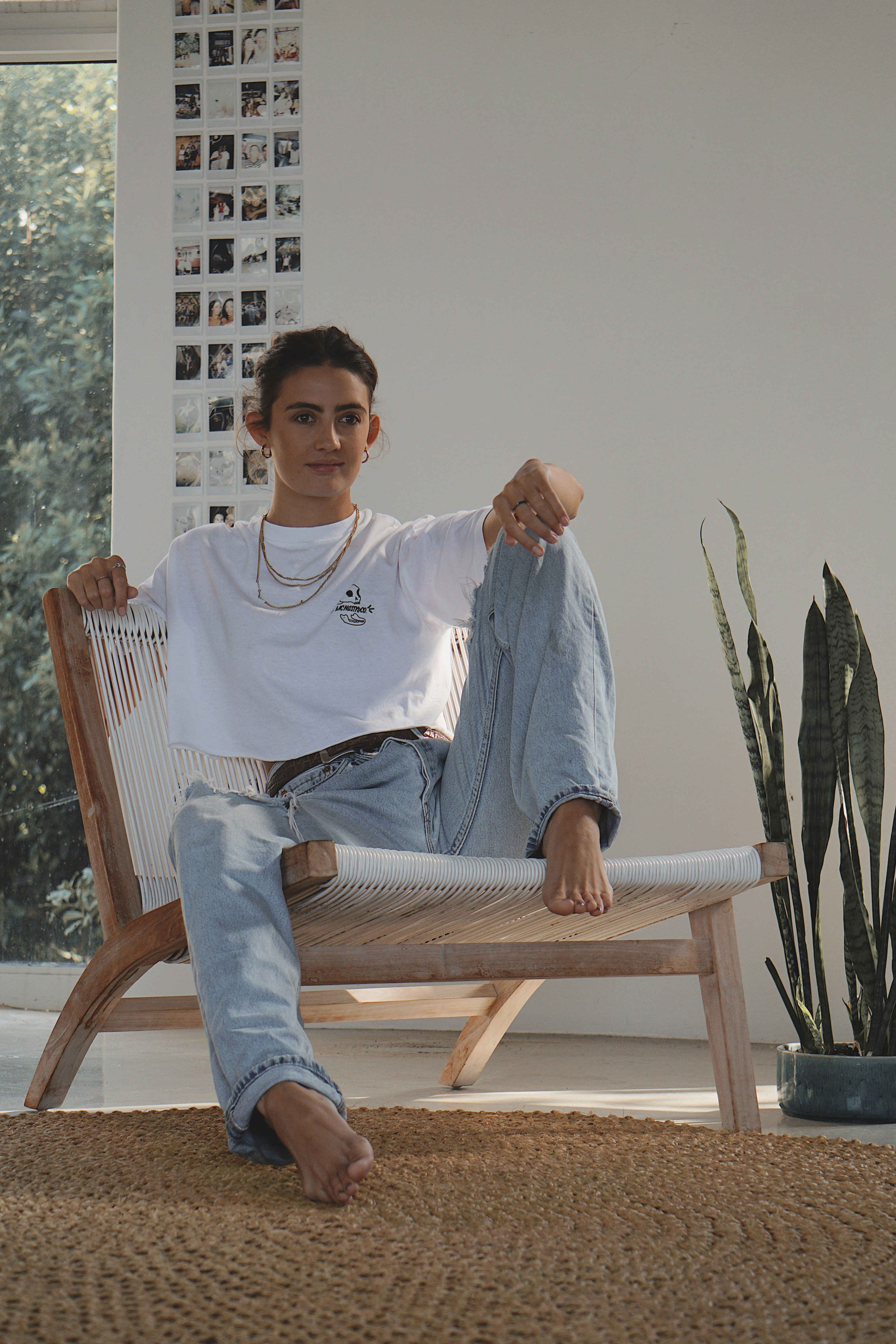 man in white crew neck t-shirt sitting on brown wooden armchair